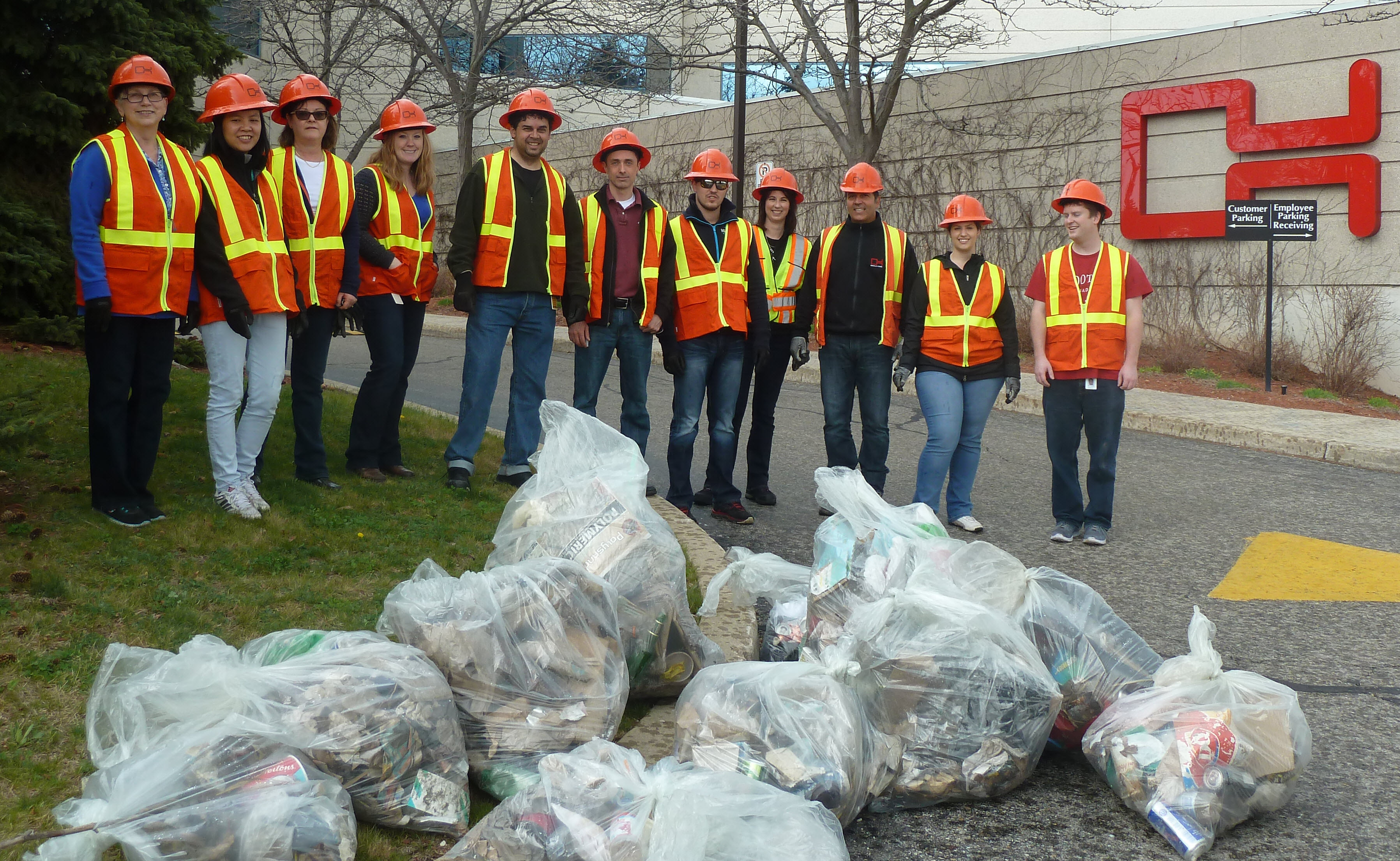 A group of Oakville Hydro employees gather with the bags of garbage collected during Clean Sweep