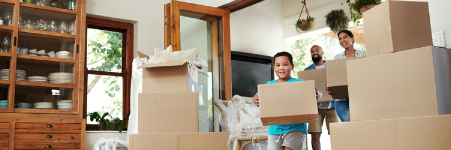 Family moving boxes into their new home