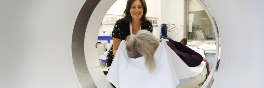 A hospital employee puts a patient into a CT scanner 
