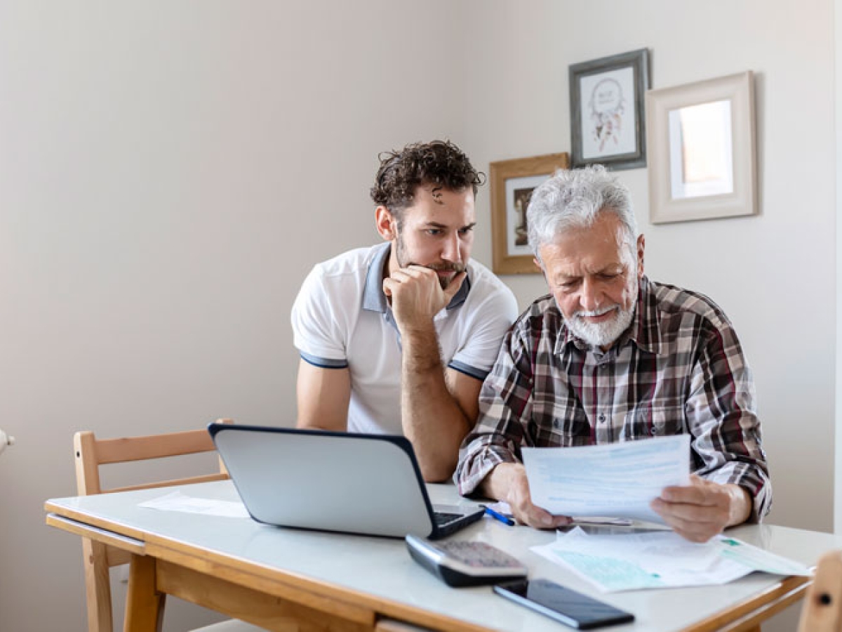 Father and son reviewing their bill Father and son reviewing their bill