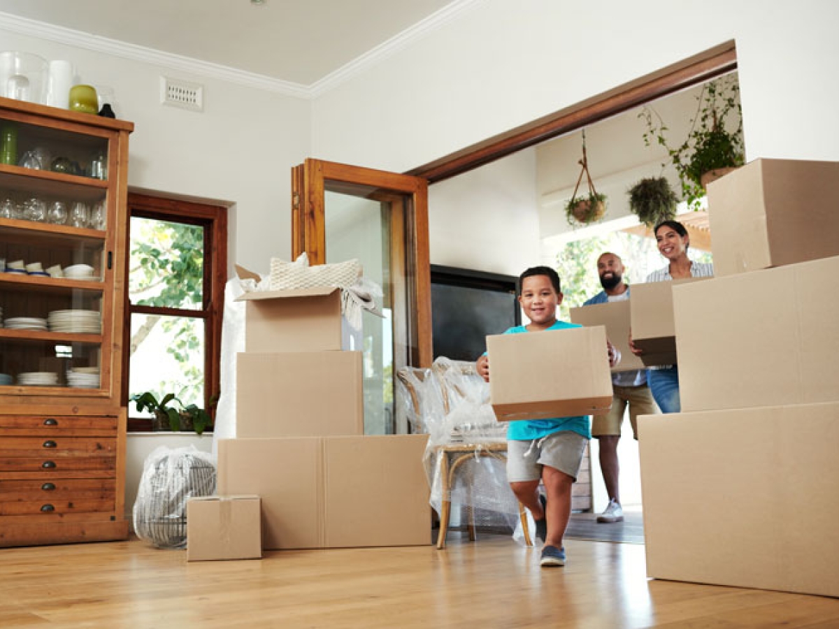 Family moving boxes into their new home